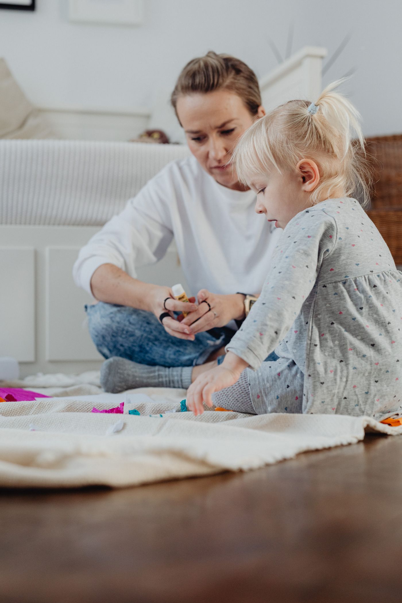 A mother and child practicing hands-on arts and crafts together