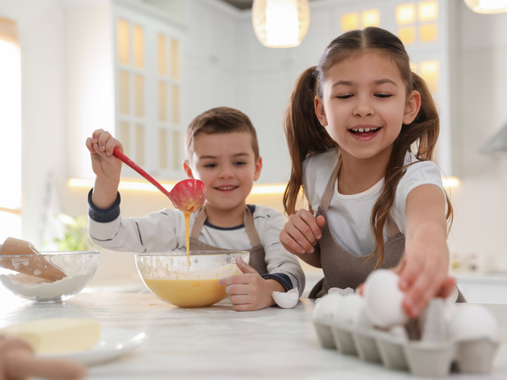 Children mixing ingredients during a hands-on cooking activity